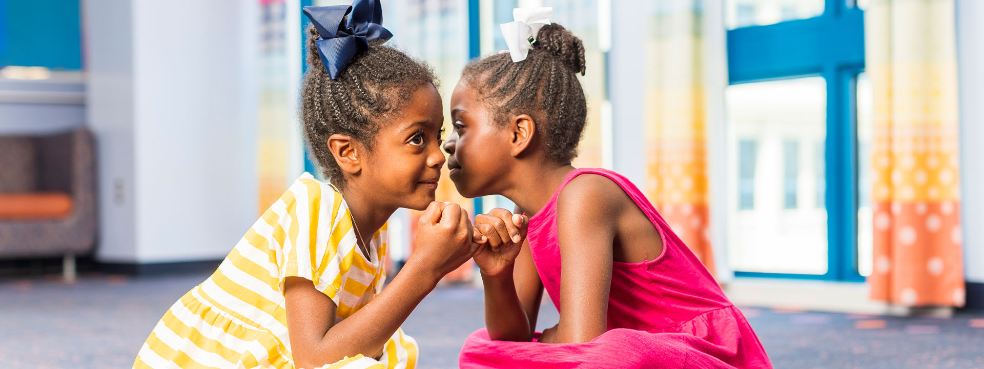 Two girls giving a pinky promise