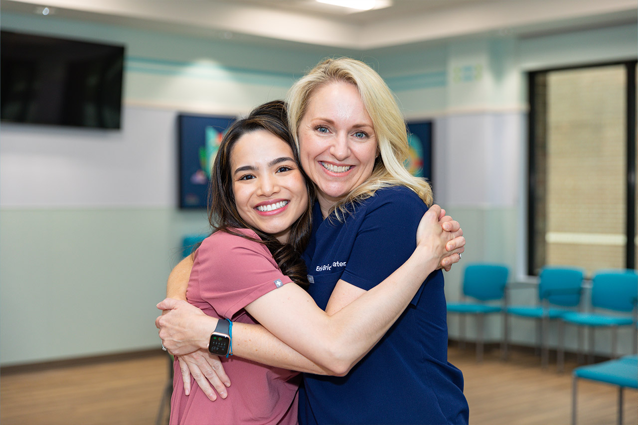 Dr. Courtney Tran and Dr. Erin Bridgewater hugging