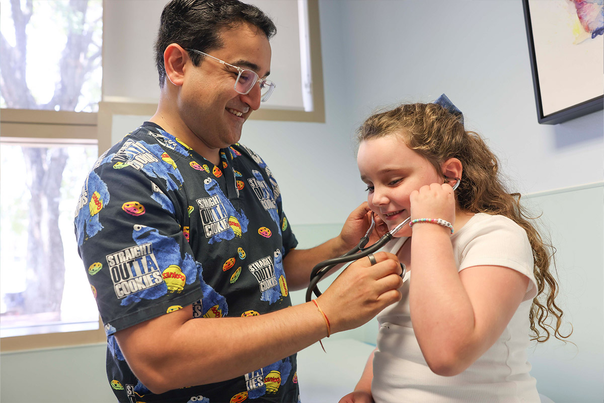Girl with stethoscope examining Dr. Bang
