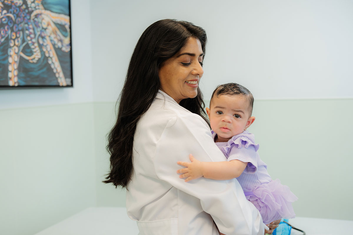 A pediatric physician examining a young baby at a children&rsquo;s primary care office in Plano, Texas