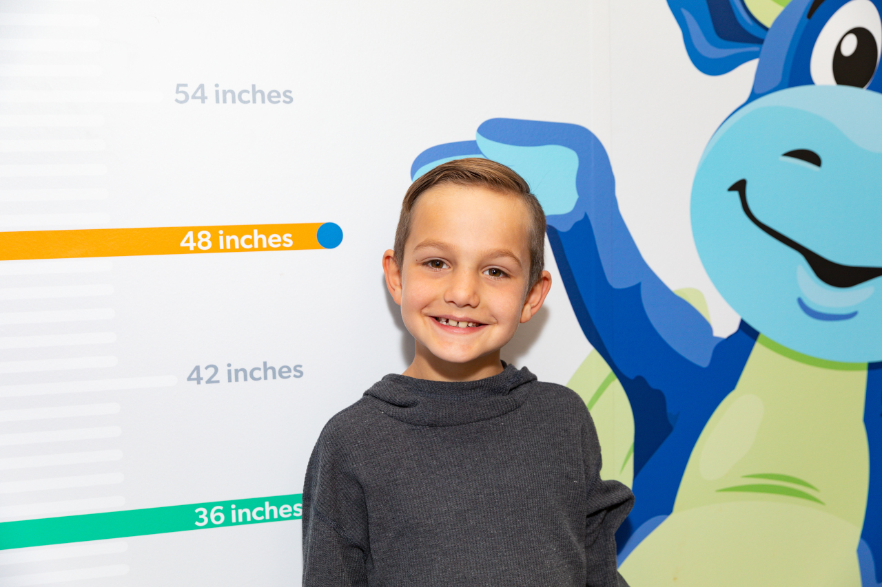 Boy next to Peaks the Dragon wall ruler