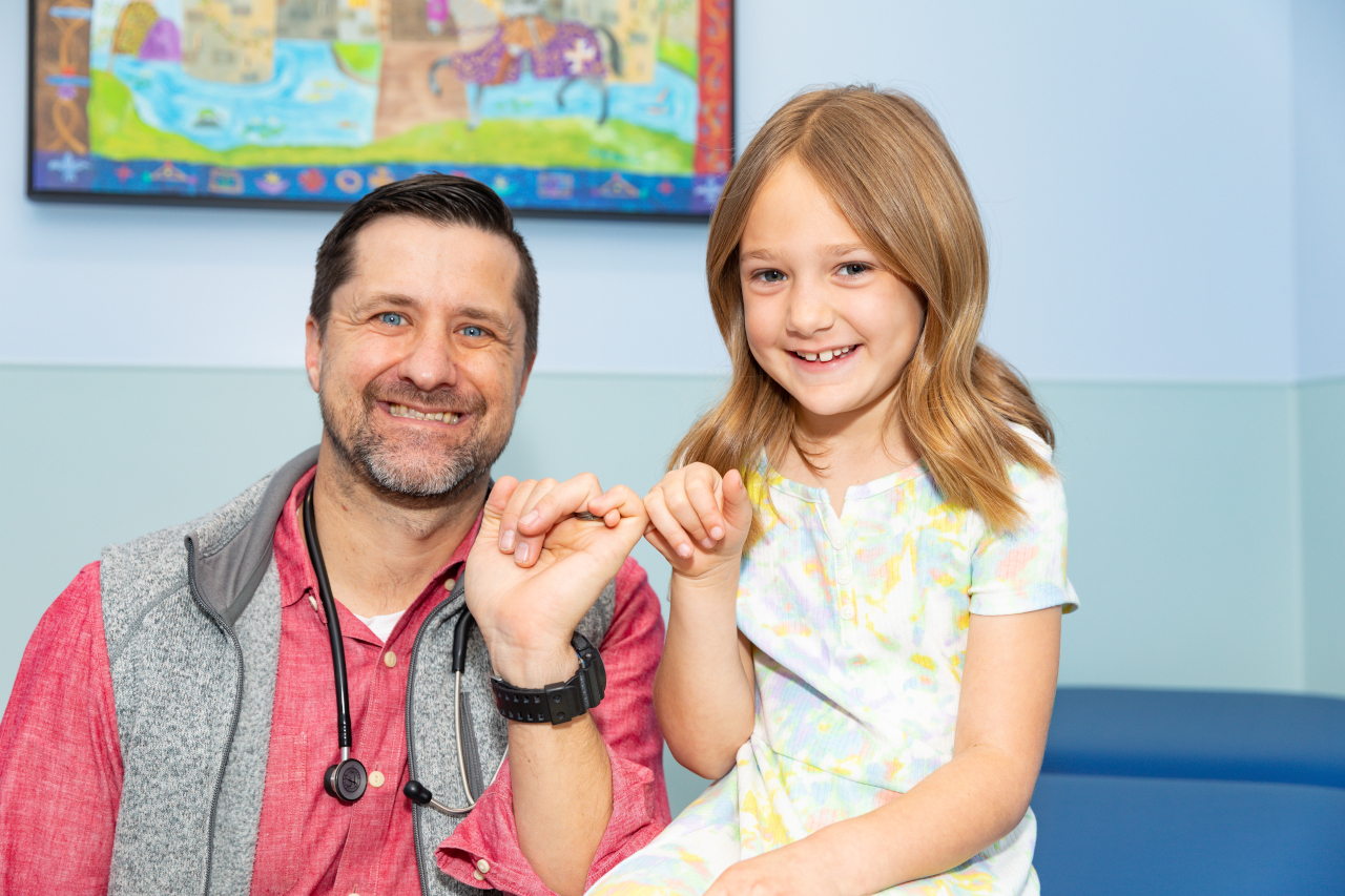Dr. Smith and girl making a pinky promise