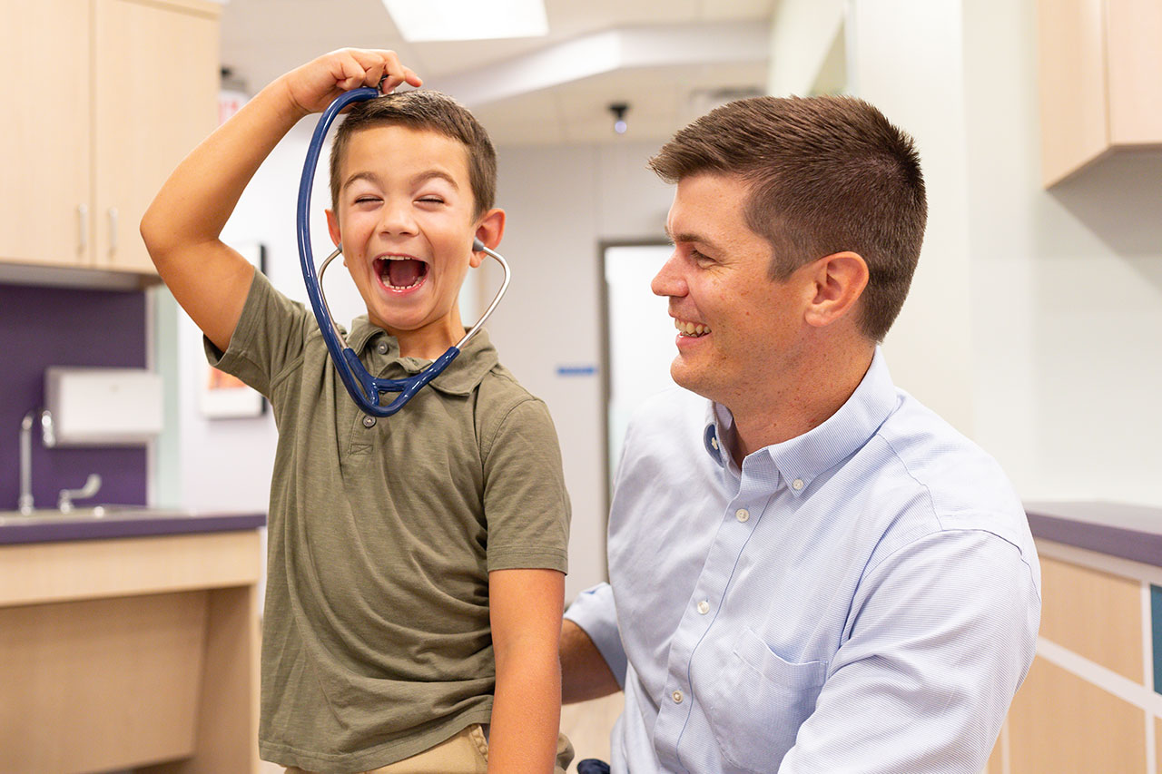Dr. Gilmore with boy and stethoscope