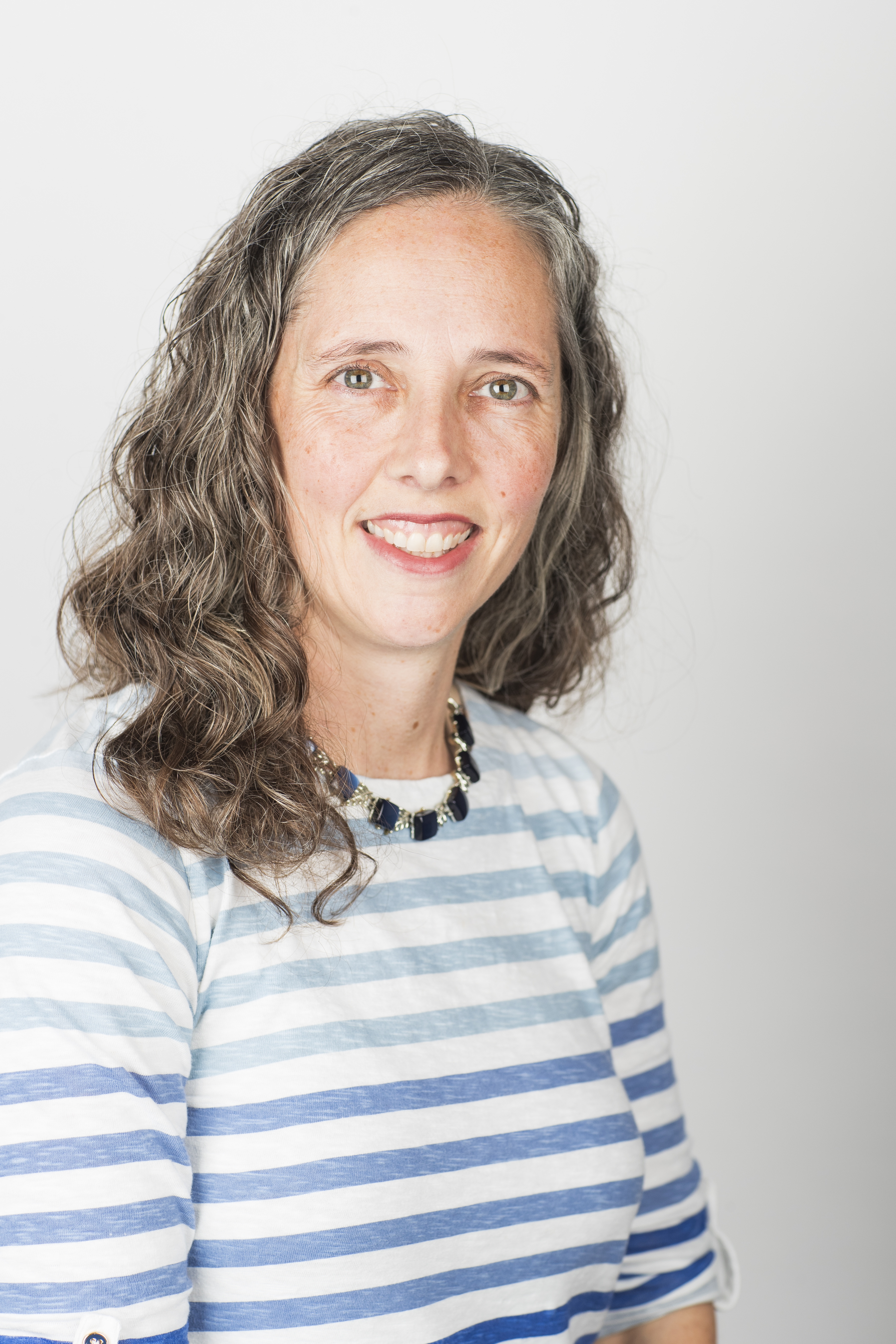 brunette female with a striped shirt on a white background