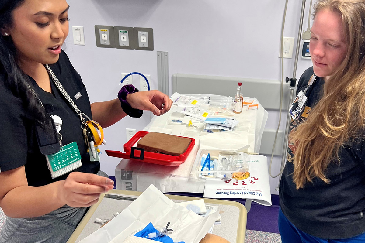 Two nurses discussing equipment