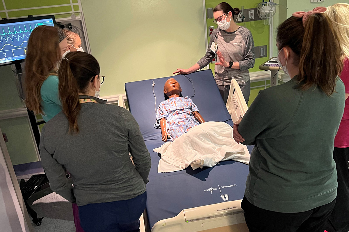 Group of nurses around a simulation